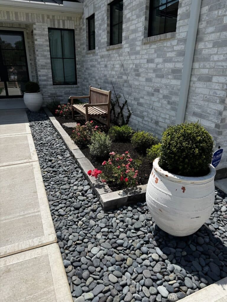 Low maintenance front yard landscaping with rocks by C4 Landscape & Design in Montgomery County, TX.